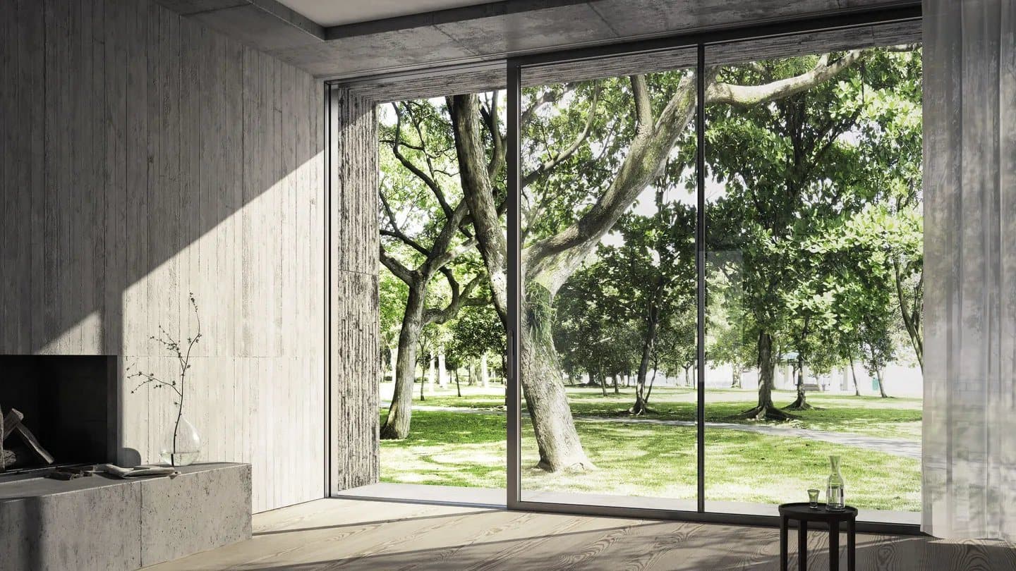Baie coulissante aluminium Schüco ouverte sur le jardin